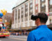 Person wearing ACESIGHT VR low-vision aid watching Macy's Thanksgiving Day Parade with family