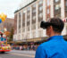 Person wearing ACESIGHT VR low-vision aid watching Macy's Thanksgiving Day Parade with family