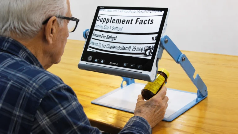 Senior reading prescription labels with Snow 12 magnifier, showcasing low vision aids for reading