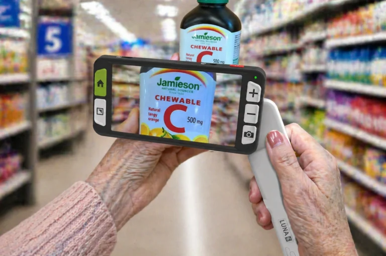 Senior using Luna 6 glaucoma low vision aids to read a vitamin bottle label in a grocery store